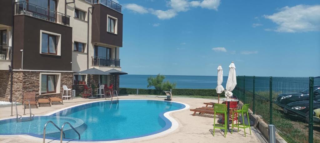 a view of a swimming pool next to a building at Swan Bay complex in Chernomorets