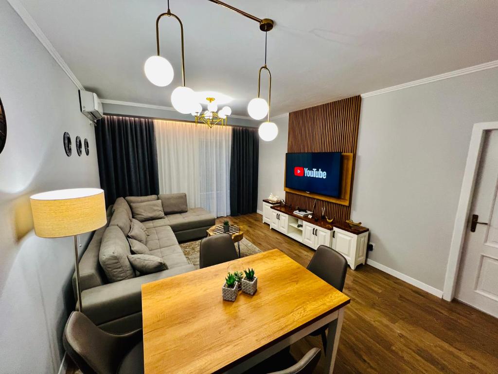 a living room with a couch and a table at Luxury Apartaments Tirana in Tirana