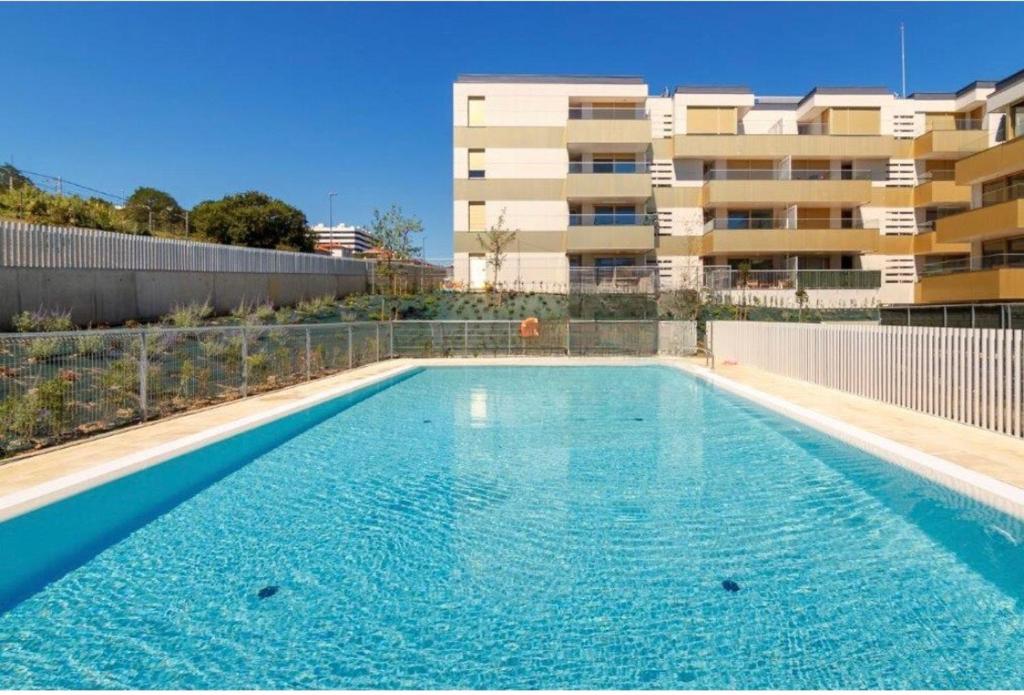 una piscina vacía frente a un edificio en A estrenar amplio con piscina y parking, en Getxo