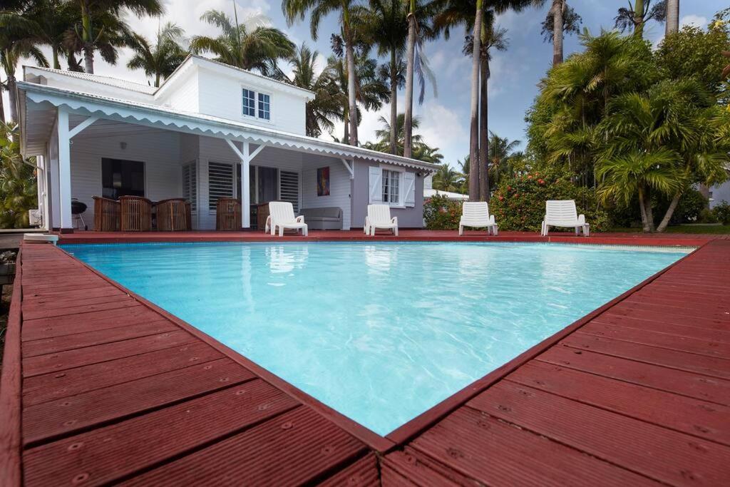 a large swimming pool in front of a house at Villa Picasso in Sainte-Rose