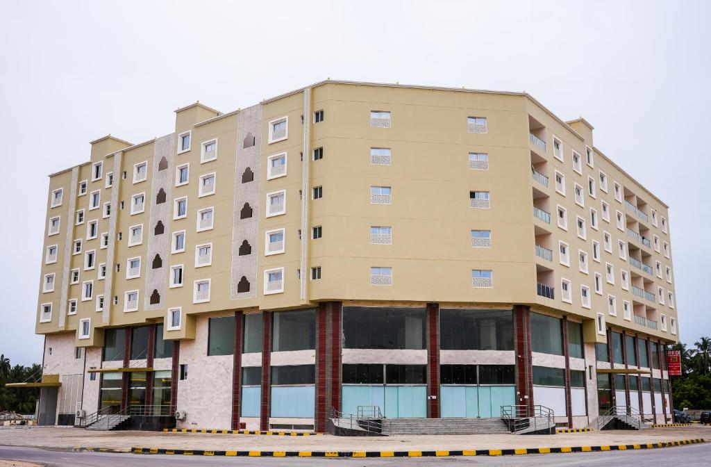 a large apartment building on the side of a street at RED Royal Inn in Salalah