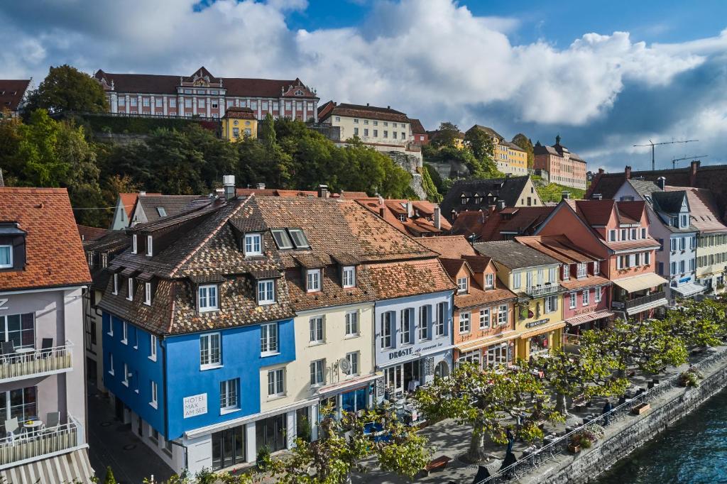 a row of houses in a town next to the water at Hotel Max am See in Meersburg