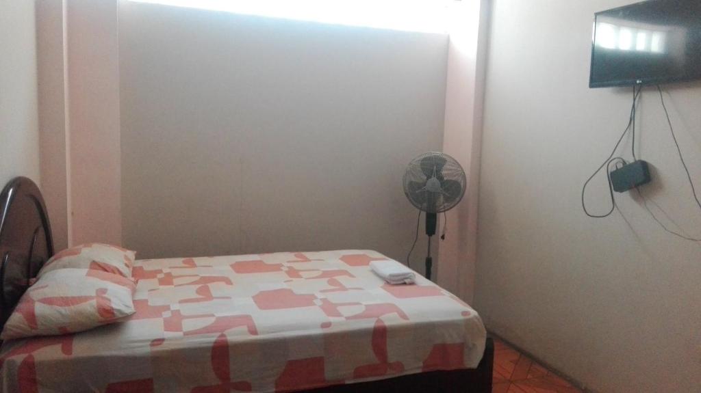 Un pat sau paturi într-o cameră la Hostal Muchik