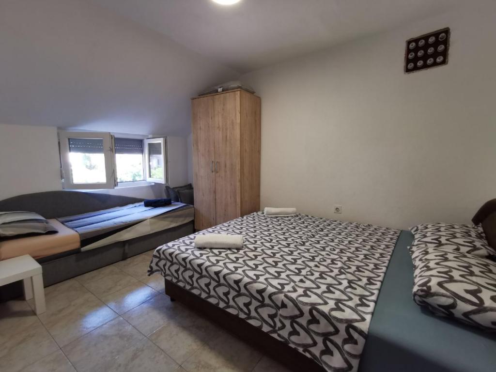 Postel nebo postele na pokoji v ubytování Apartman Kosta