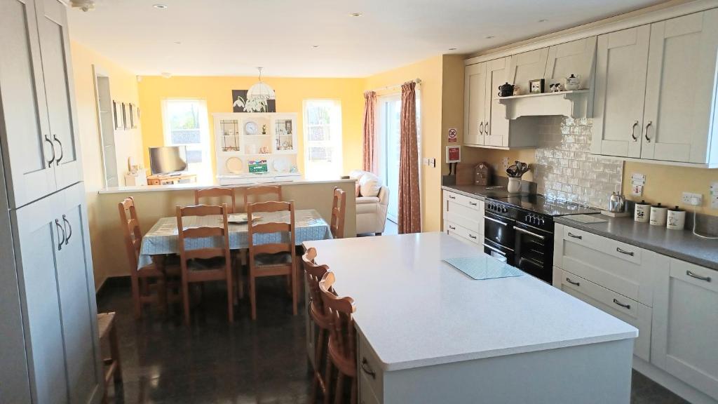 a kitchen with a table and a dining room at Causeway Coast Ground Floor Apartment Sleeps 5 in Armoy