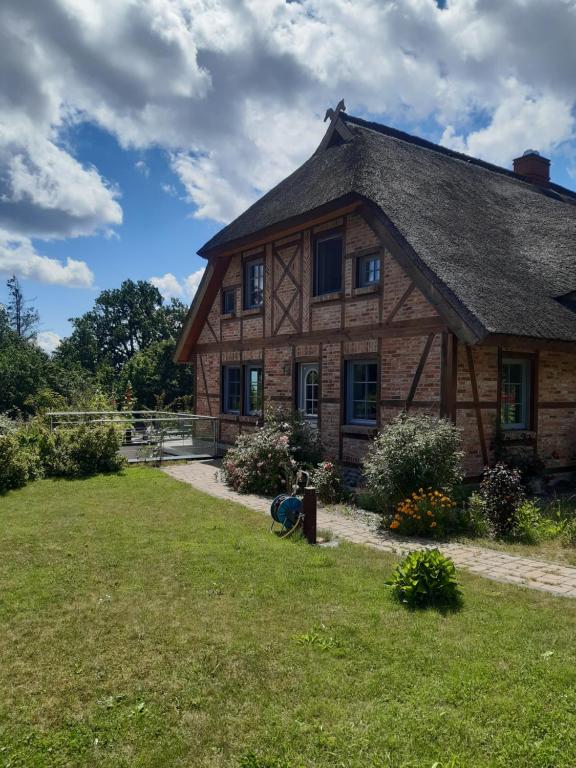 a large wooden house with a grass yard at Ferienwohnung Böttcher in Putbus