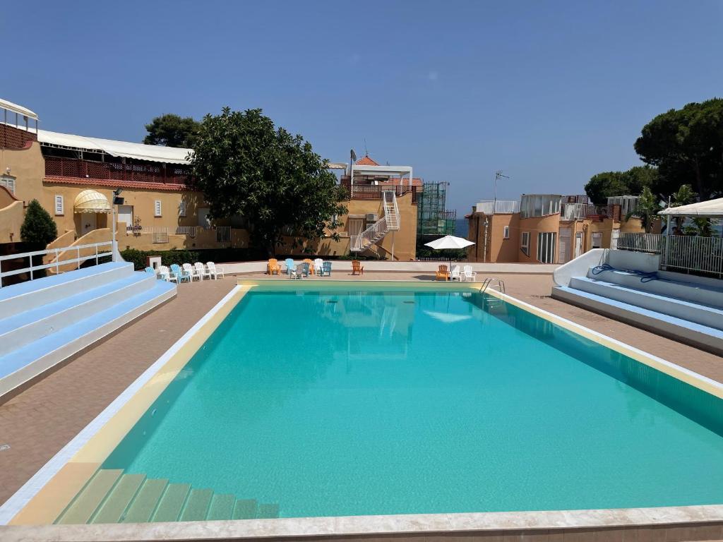 a large swimming pool on the roof of a building at Residence _Capo Gallo in Palermo