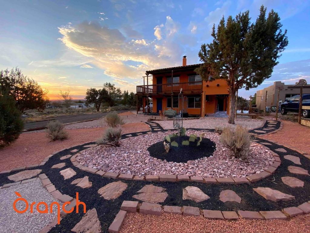 a building with a fountain in front of a house at Oranch House, Studio & Wilderness in Kanab