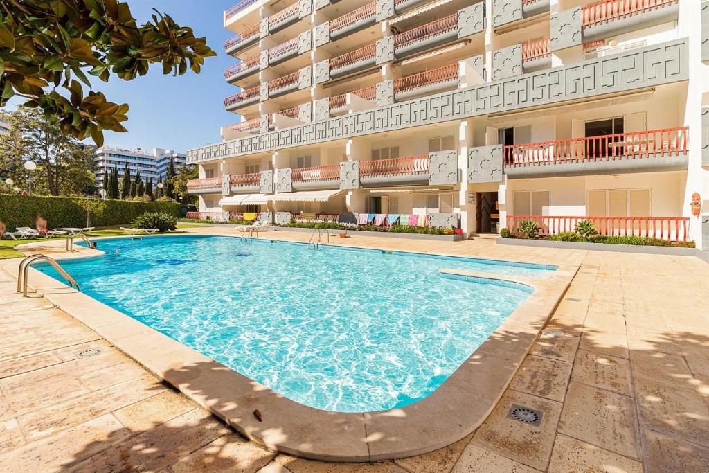a swimming pool in front of a building at Vilamoura Marina, Av Tivoli in Vilamoura