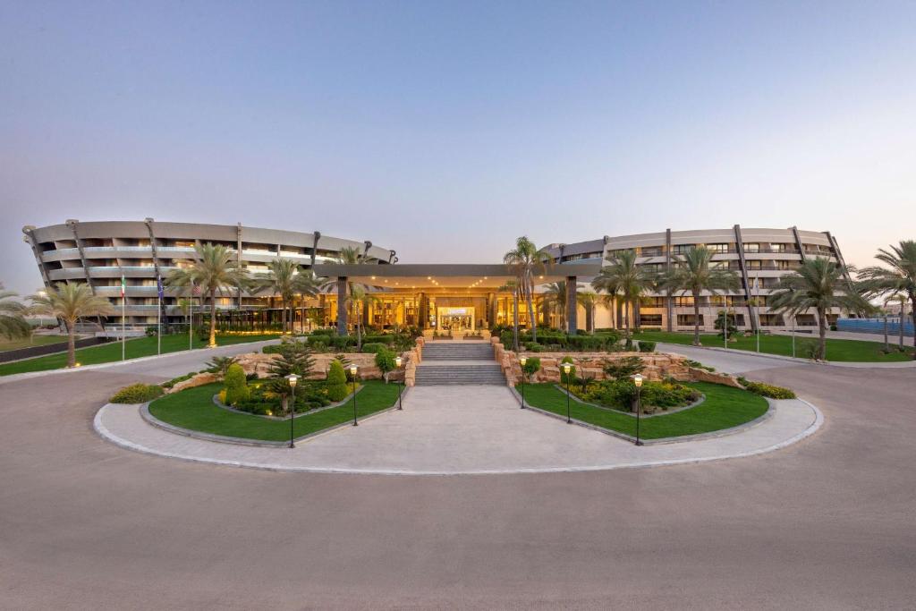 an exterior view of a building with a courtyard at Radisson Blu Hotel Alexandria in Alexandria