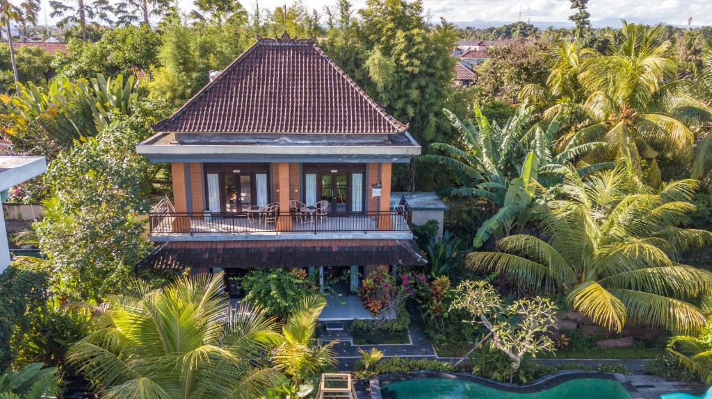 an aerial view of a house with a balcony at Adi Santia Bungalows in Ubud