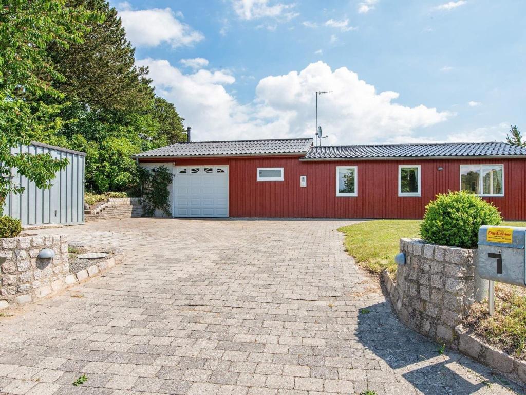 a red house with a white garage at Holiday home Ebeltoft CXCIV in Ebeltoft