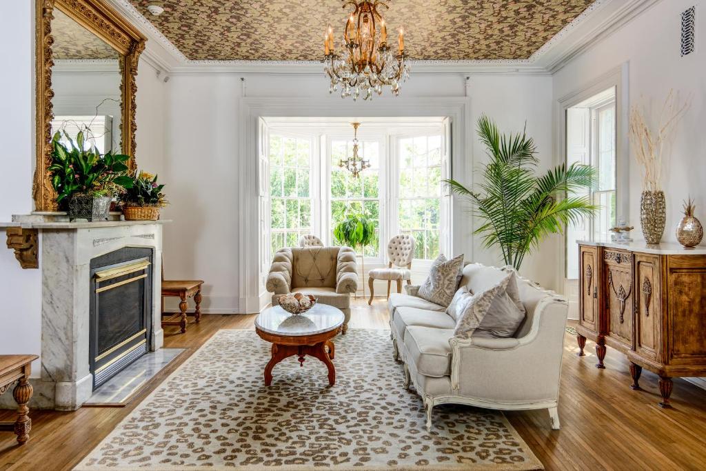 a living room with a fireplace and a chandelier at The Peninsula in Cape May Court House