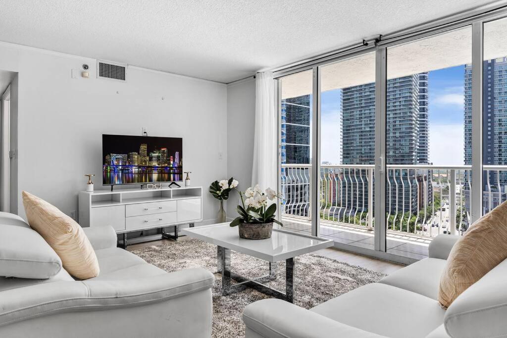a living room with white furniture and a large window at Modern 2/2 with Beautiful Ocean and Brickell Views in Miami