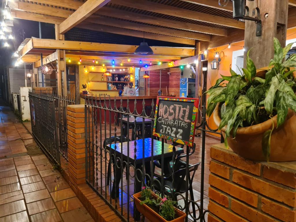 a restaurant with a gate with a sign on it at Cataratas Jazz Hostel in Puerto Iguazú