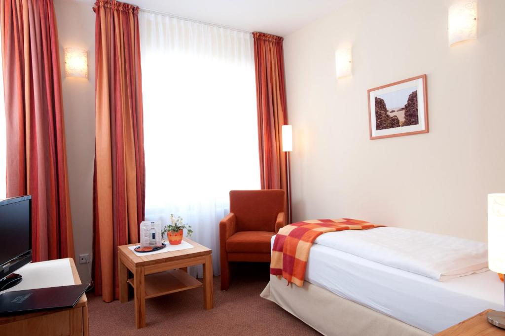 Postel nebo postele na pokoji v ubytování Hotel Gutenberg