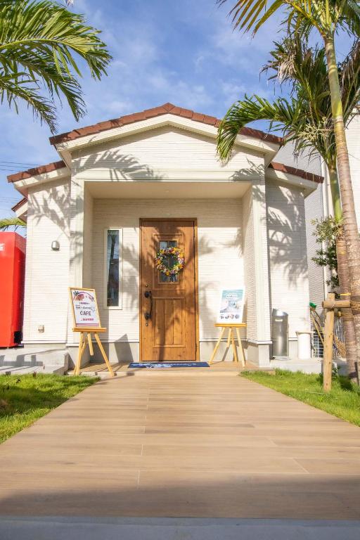 a house with two signs in front of it at Hotel Santa Barbara Miyakojima Resort in Miyako-jima