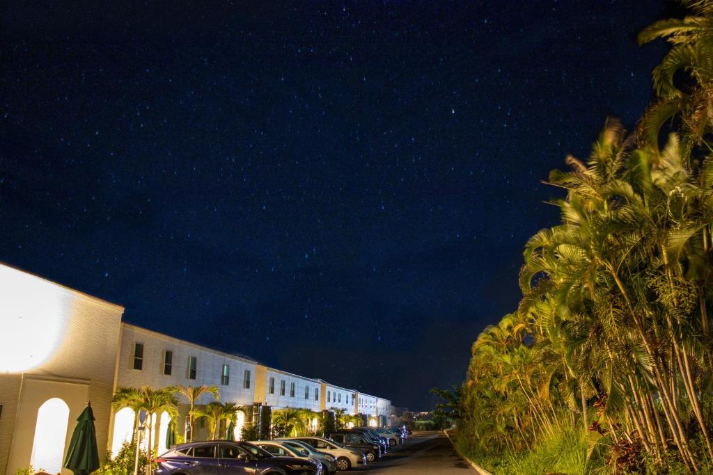 a row of cars parked in a parking lot at night at Hotel Santa Barbara Miyakojima Resort in Miyako-jima