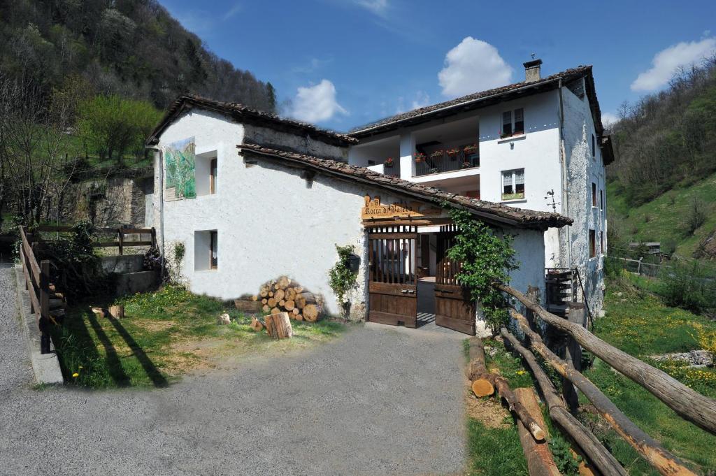 a white house with a fence in front of it at B&B Rocca di Bajedo in Pasturo