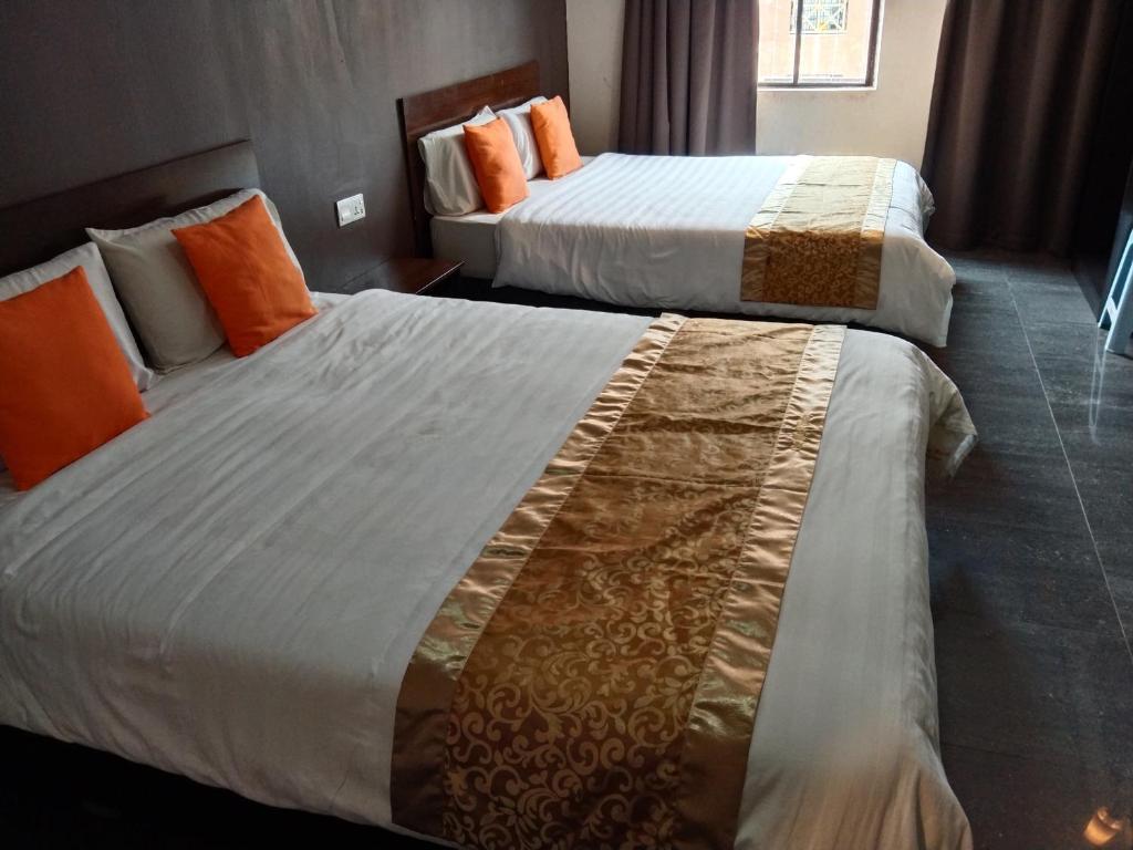 Postel nebo postele na pokoji v ubytování One World Hotel