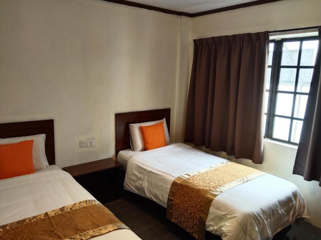 Postel nebo postele na pokoji v ubytování One World Hotel
