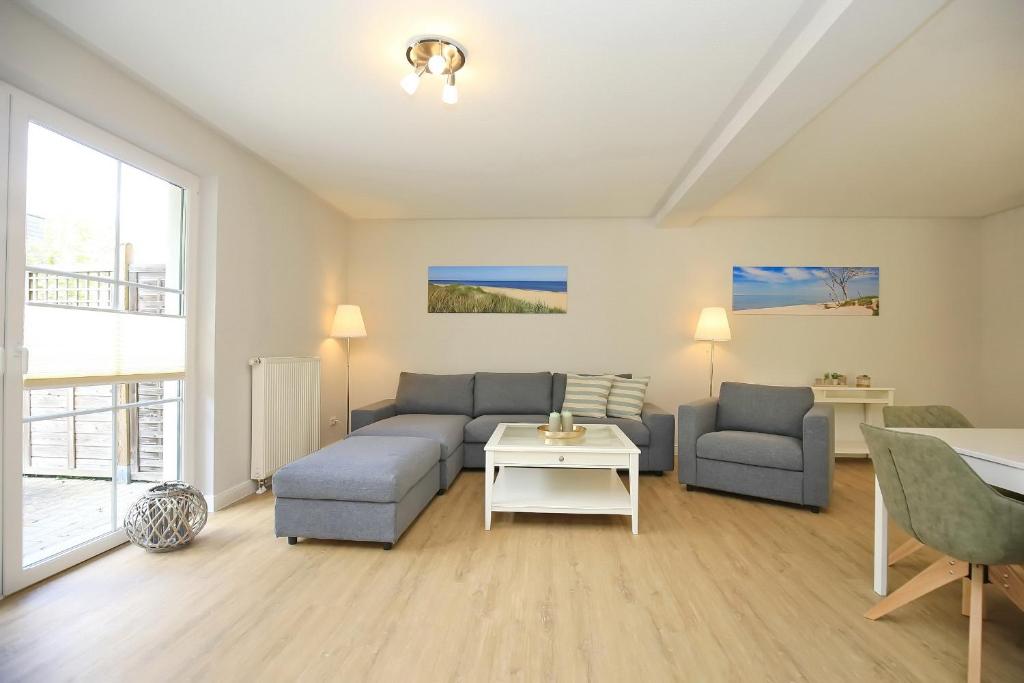 a living room with a couch and a table at Strandvilla Krabbe Wohnung 15 in Boltenhagen