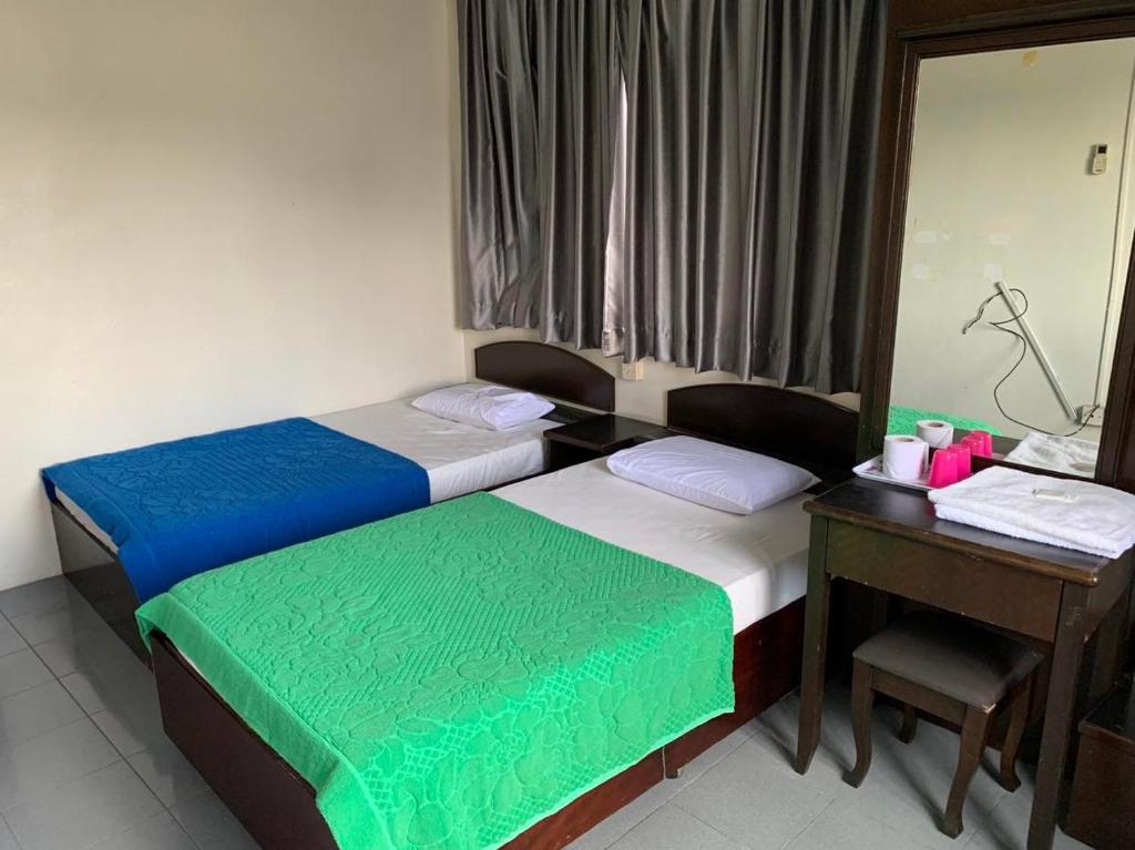 Postel nebo postele na pokoji v ubytování HOTEL MIRAMA 美麗華酒店