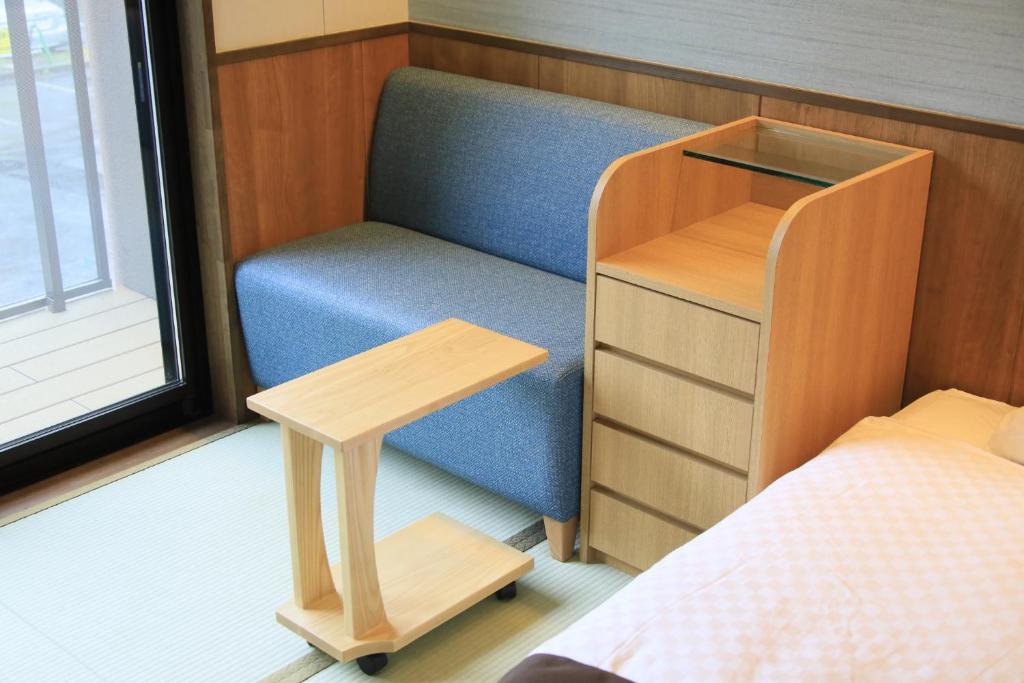 Postel nebo postele na pokoji v ubytování KusatsuOnsen AeruyadoTakamatsu