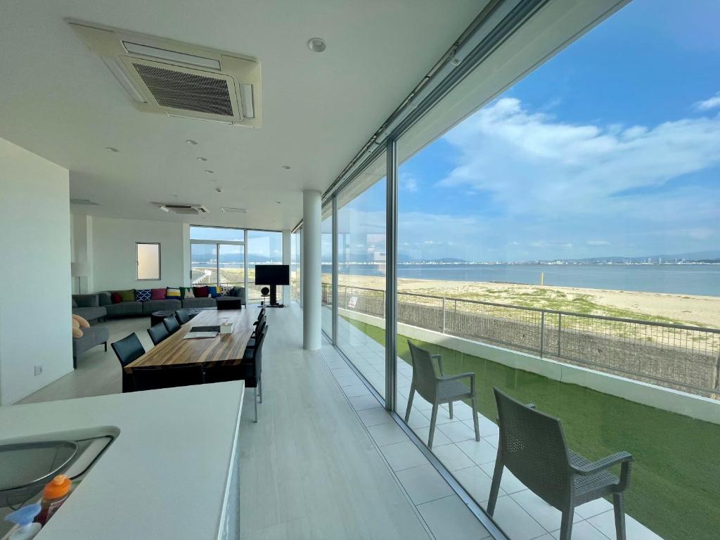 a living room with a view of the ocean at Luxury Villa Saitozaki UMIHOTARU in Fukuoka