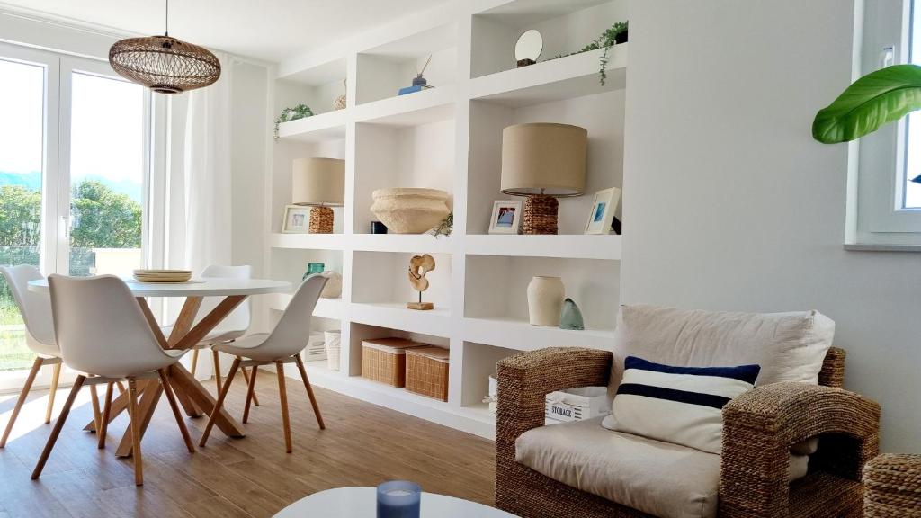 a living room with a table and chairs at Salt & Stone Villa in Pag