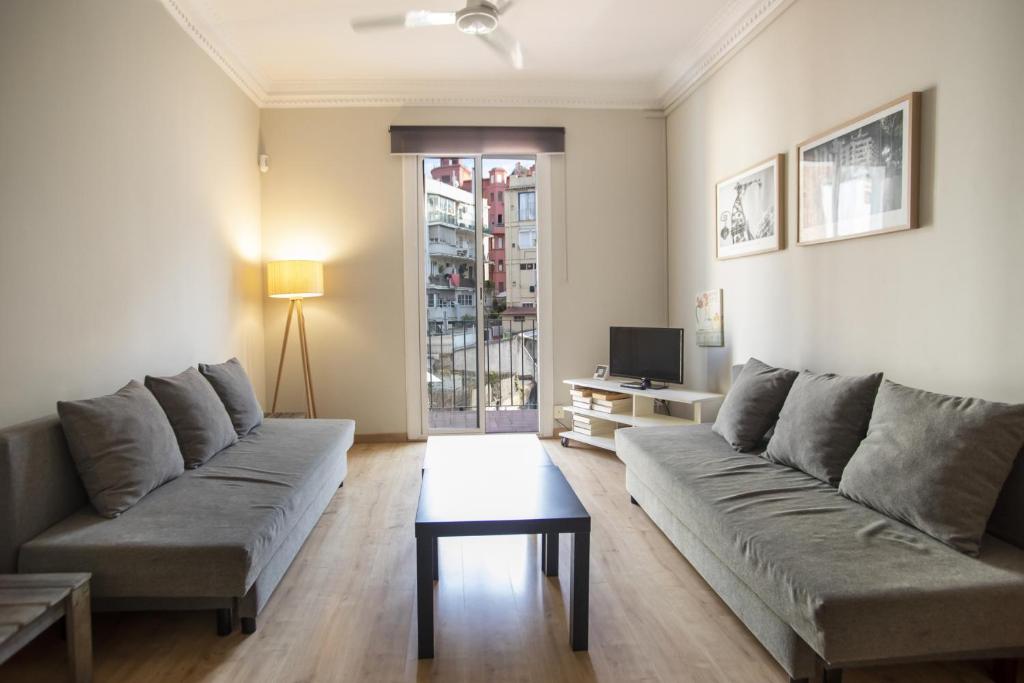 a living room with a couch and a table at 23PAR1007 Comfortable apartment in Paralel in Barcelona