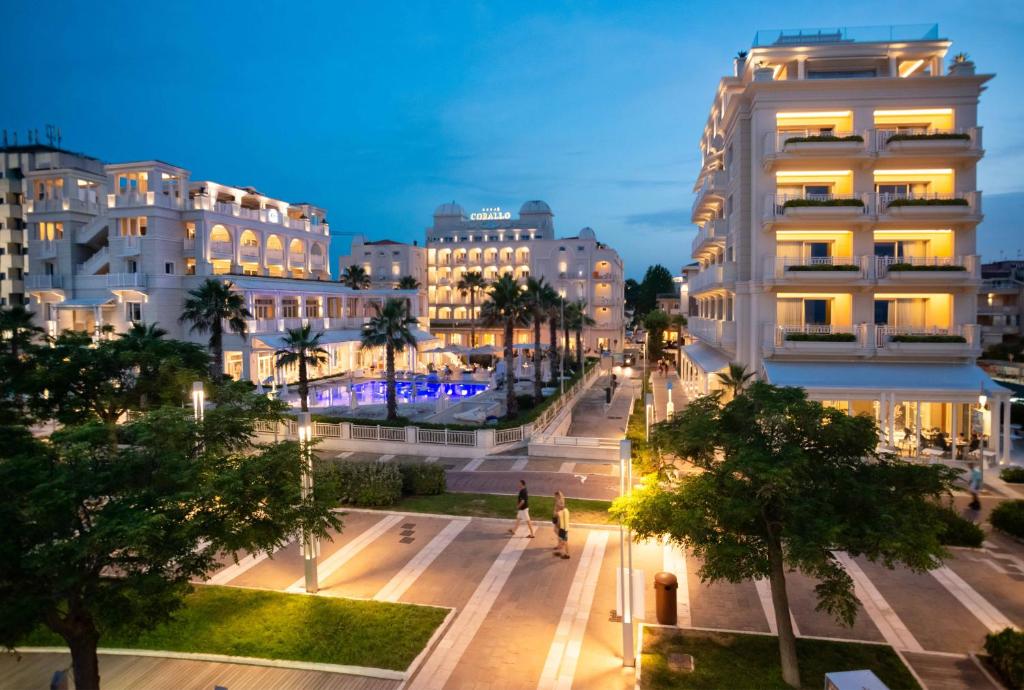 a view of a city at night with buildings at Hotel Corallo in Riccione