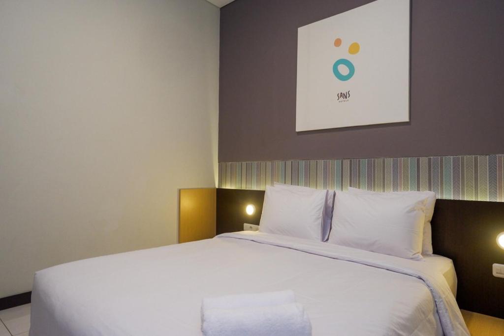 Postel nebo postele na pokoji v ubytování Sans Hotel Good Wish Semarang