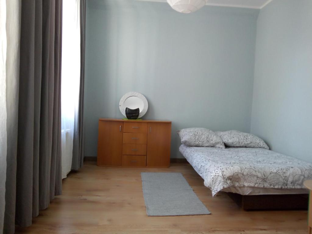 a bedroom with a bed and a dresser with a mirror at Apartament Maja2 2 pokoje na Gdańskiej starówce parking w cenie in Gdańsk