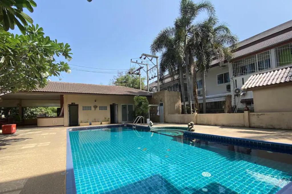 a swimming pool in front of a building at C.A.P Mansion in Phuket