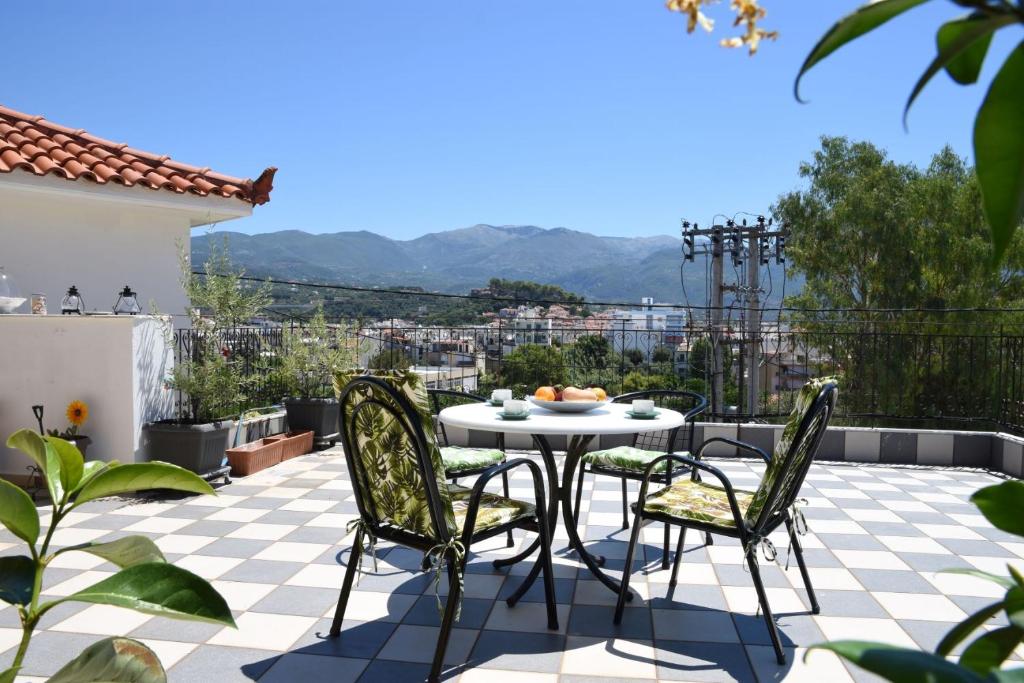 d'une terrasse sur le toit avec une table et des chaises. dans l'établissement The Yellow Art Home, à Kalamata