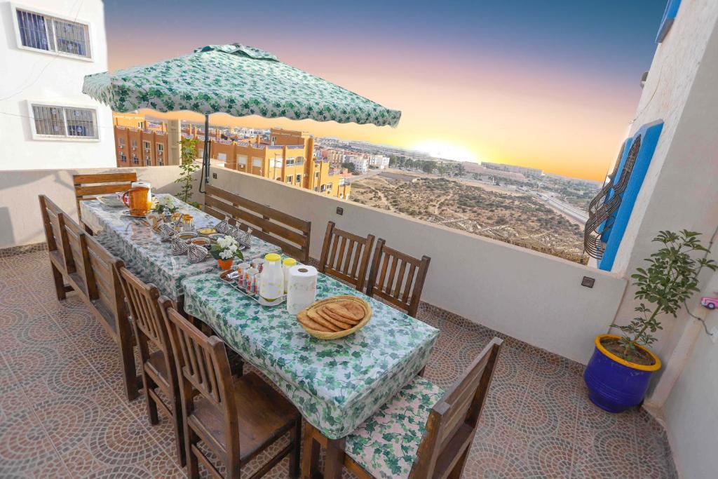 a table in a restaurant with a view of the beach at The Rina Hostel in Agadir