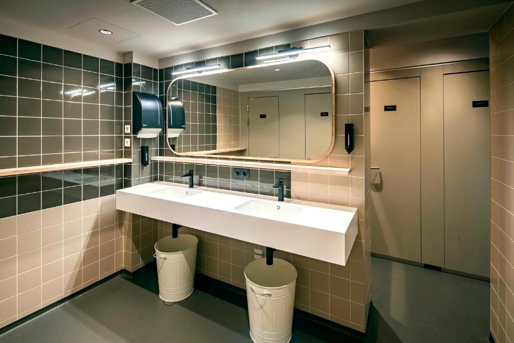 a bathroom with a sink and a mirror at The Bee Hostel in Amsterdam