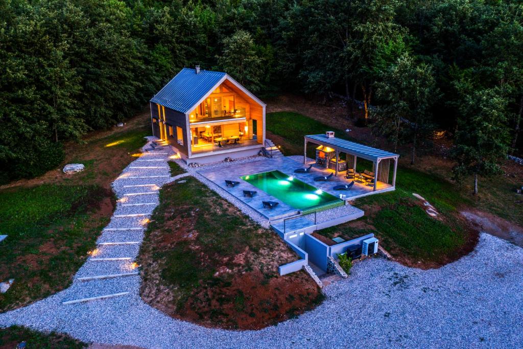 an aerial view of a house with a swimming pool at Villa Lovelos in Lovinac