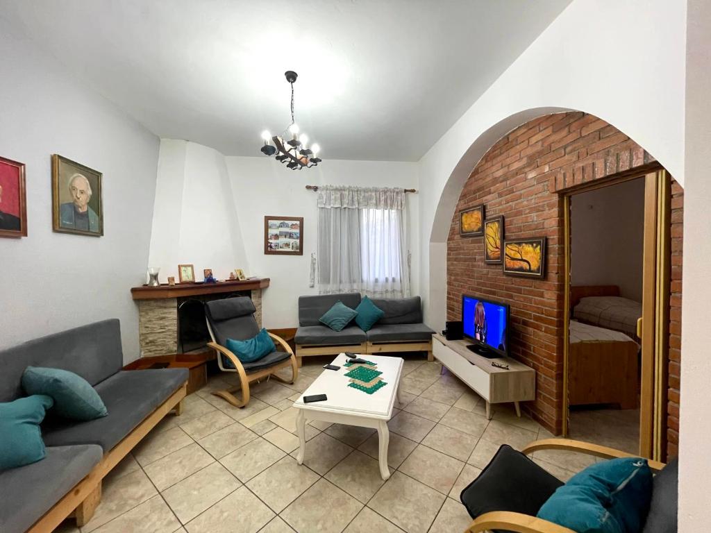 a living room with a couch and a table at Green Coast Villa - Tragjas Village in Vlorë