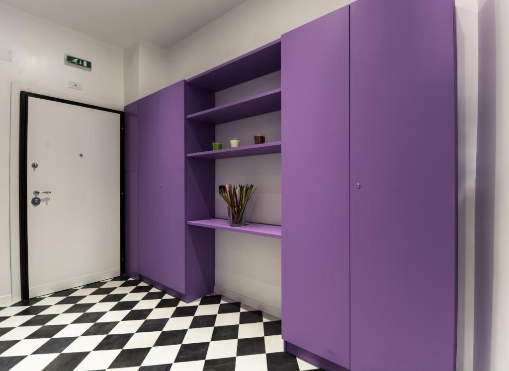 a purple closet in a room with a checkered floor at Affittacamere Tiburstation 2 in Rome