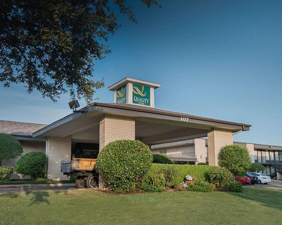 um edifício com um sinal em cima em Quality Inn em Ennis