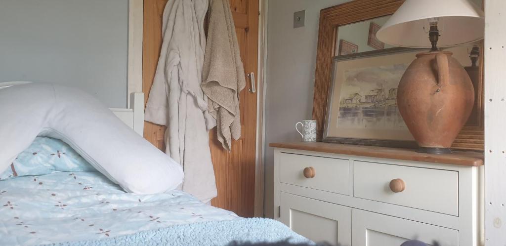 a bedroom with a bed and a picture on a dresser at Comfy Cosy Room Tv fridge microwave in Upton