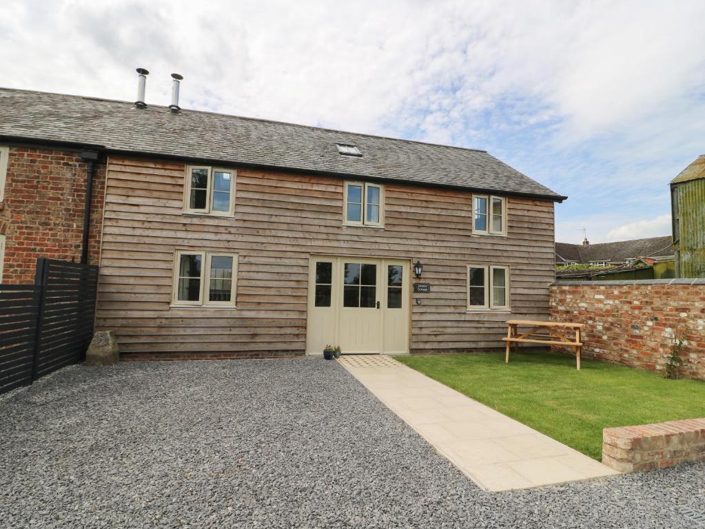 a house with a garage and a brick building at Joiners Cottage in York