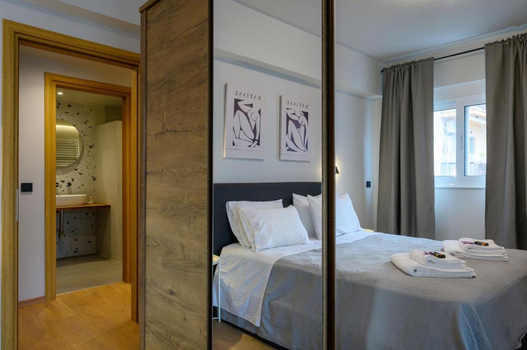 a bedroom with a bed and a large mirror at Plato 88 in Kalamata