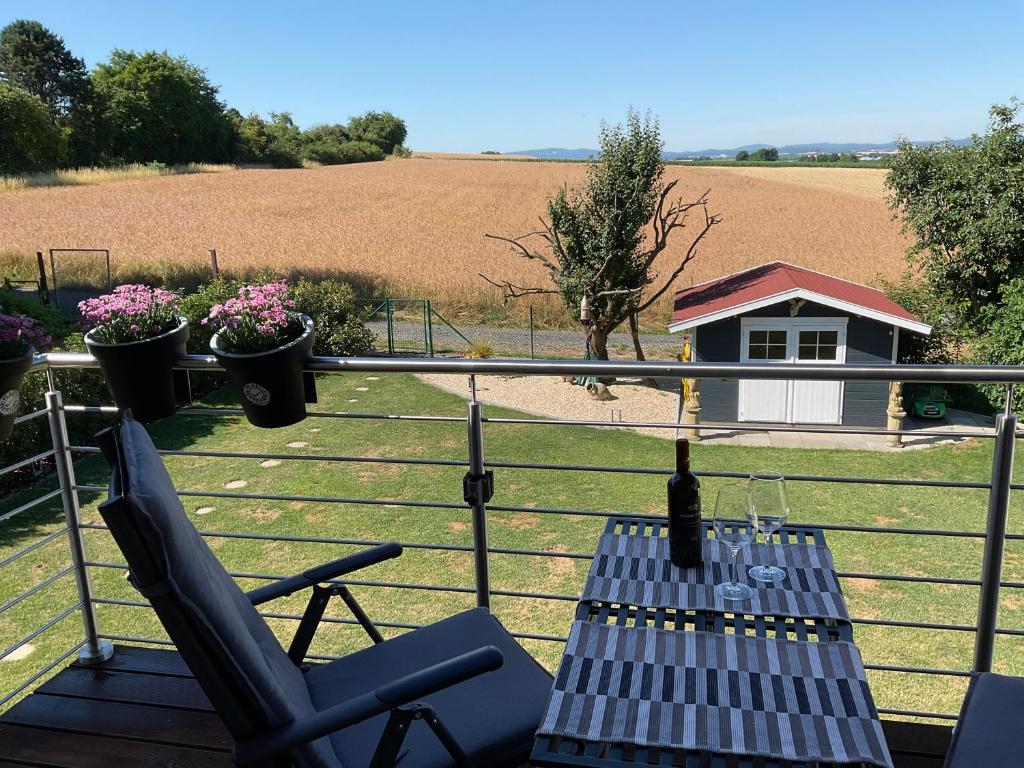 a deck with a table and chairs and a field at Charmante Ferienwohnung 100 qm in Groß-Umstadt