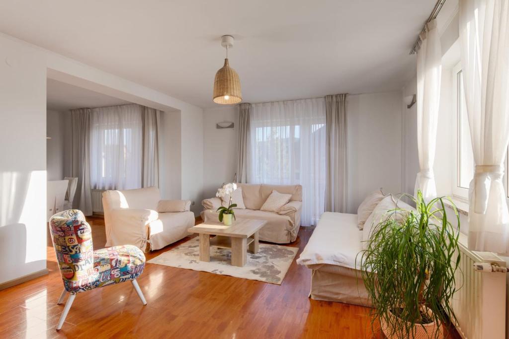 a living room with a couch and a chair at Apartments Nika in Slunj