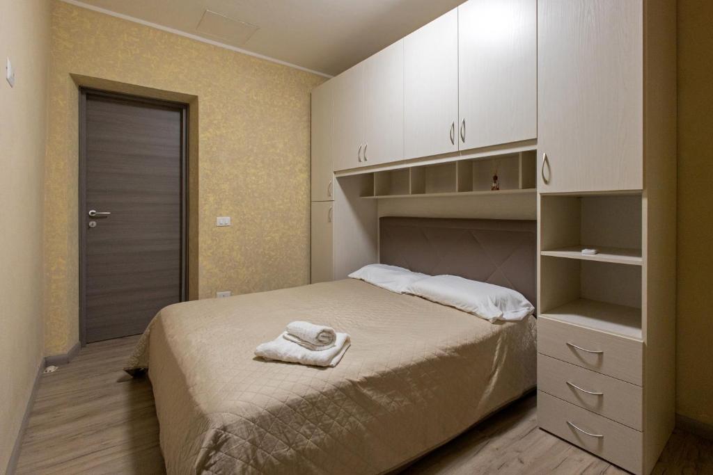 a bedroom with a bed with a towel on it at Stella room & apartment in Marsala