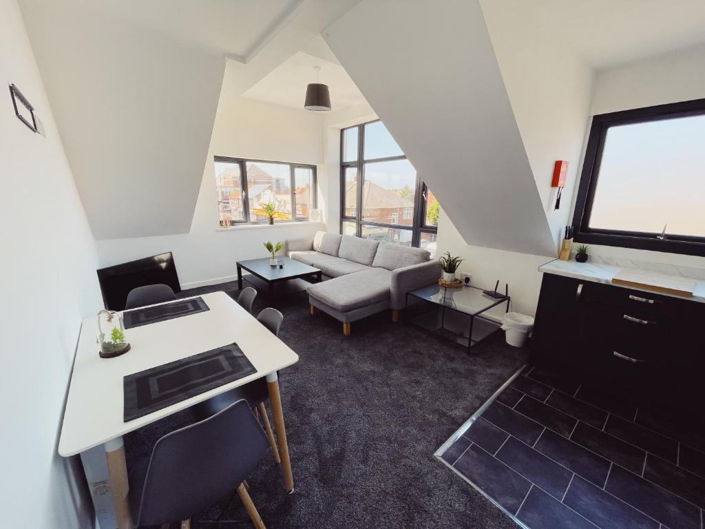 a living room with a couch and a table at 2 Bed New Build Apartment - Sleeps 6 - Close to City Centre - Free Parking in Elswick