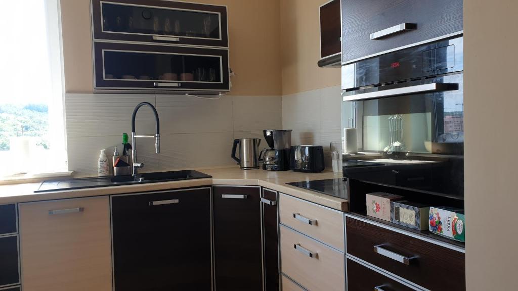 a kitchen with a sink and a stove top oven at ALBATROS in Gdynia